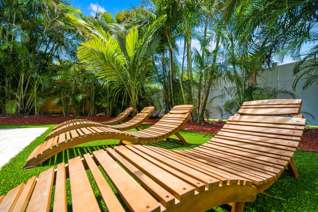 Wooden lounge chairs in pool area in Vacation Home Rental